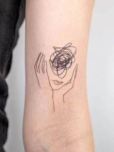 a woman's arm with a tattoo design on the left side of her arm