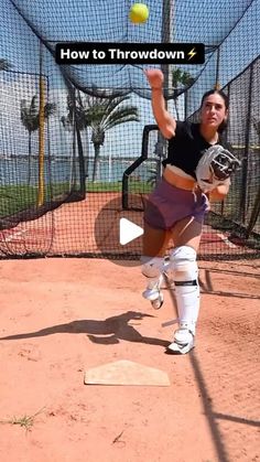 a woman in purple shorts and black shirt throwing a ball on a baseball field with the words how to throwdown