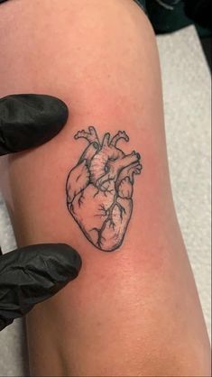 a small heart tattoo on the leg