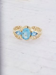 Vintage Blue Topaz filigree ring. Details: Size: US 9 ( can be sized ) Weight: 3.4 grams Primary stone: Blue Topaz Shape: Oval ( Appx. 8mm x 6mm ) Secondary Stone: Blue Topaz Shape: Pear Metal: 14k Yellow Gold Condition: Brand new! Inside of band is stamped and tested for '14k' gold. SIZING: Currently this ring is a size 9 but could be sized up or down for an additional small fee if desired by adding custom ring sizing to your cart upon checkout. Most sizing can be done within 1-3 days. PACKAGIN Custom Ring, Filigree Ring, Multi Stone Ring, Multi Stone, Custom Rings, Stone Rings, Online Jewelry, Precious Metals, Blue Topaz