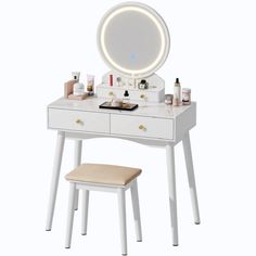 a white vanity table with a mirror and stool