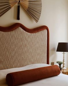 a bed with an upholstered headboard in a bedroom