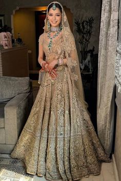 a woman in a bridal gown posing for the camera