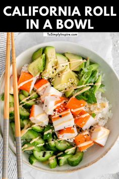 a bowl filled with rice, cucumber and carrots next to chopsticks