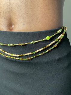 Beaded Belly Chain "Twilight Forest" – a luxurious harmony of small 18k gold plated seed beads, warm brown glass seed beads, and larger green crystal accent seed beads. Meticulously handcrafted, this belly chain radiates opulence and natural allure, with a customizable fit that ensures comfort and style tailored just for you. ✨ Gold: The belly chain features a cascade of small 18k gold plated seed beads, embodying gilded opulence and radiating a rich, golden allure. Gold symbolizes wealth and pr Waist Beads And Belly Button Piercing, Wire Seed Bead Jewelry, Cheap Bohemian Style Beaded Waist Beads, Seed Bead Belly Chains, Stomach Chain Body Jewelry, Seaweed Accessories, Waist Beads With Charms, Mermaid Waist Beads, Waist Jewelry Beads