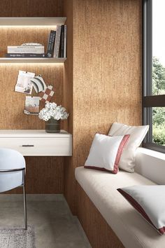 a white chair sitting next to a window in a room filled with books and pillows