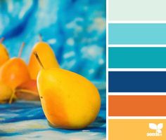 there are several small yellow ducks on the blue and orange tablecloth with matching colors