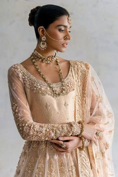 Pakistani Bridal Lehenga with Pishwas Frock and Dupatta is a traditional masterpiece that will give the gorgeous bride a head-turning look at the wedding. Lavish designs and hand-crafted details of zardosi make this beautiful Pakistani Bridal Dress your foremost priority for the big day. Pakistani Bridal Pishwas: Pakistani Bridal Pishwas has an alluring peach color and it comes in premium net fabric. The neckline, panels, and sleeves of this Pishwas Frock are hand-embellished with zardosi and Re Pishwas Pakistani, Bridal Pishwas, Pakistani Bridal Lehenga, Pakistani Bridal Dress, Walima Dress, Zardosi Work, Bridal Dupatta, Nikkah Dress, Lehenga Style