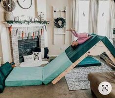 a woman laying on top of a slide in a living room