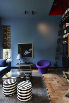 a living room with blue walls and furniture