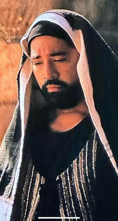 a man with a beard wearing a black and white robe