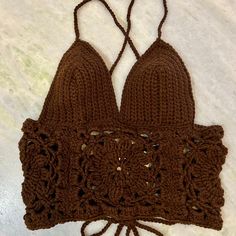 Crochet crop top is size medium with adjustable corset straps Bohemian Crop Top With Built-in Bra For Festivals, Fitted Bohemian Brown Crop Top, Fitted Cropped Halter Top With Straps, Fitted Crop Top Halter For Music Festival, Fitted Brown Triangle Halter Top, Brown Fitted Triangle Halter Top, Music Festival Fitted Halter Crop Top, Beach Crop Top With Straps, Fitted Crop Halter Top For Festivals