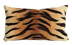 a tiger print pillow on a white background