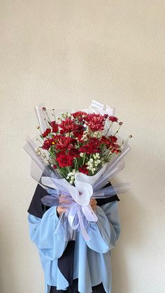 a bouquet of red flowers in a blue vase