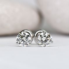 These timeless and elegant stud earrings are a true staple in any girl's jewelry box! 3 prong "cocktail style" setting Set with stunning lab grown diamonds Choose your center lab grown diamond: Better: an eye-clean diamond that's very slightly warm in color (SI+ clarity, GHI color) Best: an impeccable diamond, that's completely colorless (VS+ clarity, DEF color) Earrings weighing 1.00ct (total per pair) or above are crafted with threaded screw back posts, to ensure you never loose them. You're w Minimalist Brilliant Cut Round Diamond Earrings, Minimalist Round Cut Brilliant Diamond Earrings, Timeless 14k White Gold Diamond Earrings, Timeless 14k White Gold Vvs Clarity Diamond Earrings, Timeless Lab Grown Diamond Earrings With Prong Setting, Timeless Lab-grown Diamond Earrings With Prong Setting, Minimalist Brilliant Cut White Gold Diamond Earrings, Elegant Round Cut Diamond Earrings With Tension Setting, Minimalist White Gold Diamond Earrings With Vvs Clarity