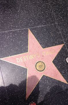 a person standing next to a star on the hollywood walk of fame