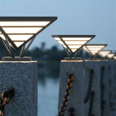 three concrete posts with lights on top of them