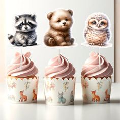 there are three cupcakes with different animals on them