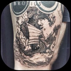 a man's leg with a ship tattoo on it