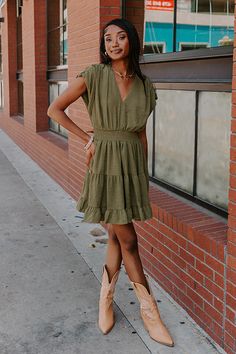 - Twirl into the season with this trendy dress! - Fully lined material - A v-cut neckline with a button closure back with a keyhole detail - Short, ruched sleeves - A cinched smocked waistline - A figure flattering silhouette that ends in a ruffled mid-thigh length hemline Chic Olive V-neck Dress, Casual Khaki V-neck Dress, Green V-neck Dress With Smocked Back, Khaki V-neck Dress For Day Out, Lace Up Wedges, Faux Leather Heels, V Cuts, Lace Up Heels, Lovely Dresses