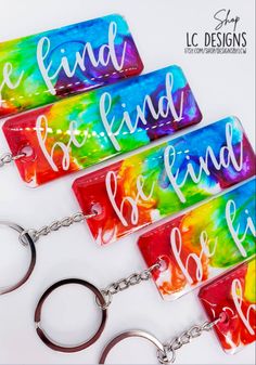 four keychains with the words be kind of friend on them, sitting next to each other