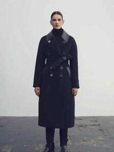 Classic and elegant. Hand-stitched double-faced wool coat. Wide shoulder look. Bust slightly wider than waist, resulting in a draped appearance. Finished with tailored dot and a matching belt. Double-face wool coat with a long scarf. Relaxed-fit, calf-length coat. Casual silhouette. Slits at sides of hem. Unlined. Shop Scarf Detail Double Face Wool Wrap Coat - Brown here. Designer Black Long Wool Coat, Black Luxury Long Pea Coat, Luxury Black Long Pea Coat, Black Belted Wool Coat For Fall, Black Belted Wool Coat, Designer Belted Outerwear For Fall, Black Belted Wool Coat For Winter, Black Belted Long Pea Coat, Black Belted Pea Coat For Fall