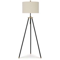 a tripod floor lamp with a white shade on top and black legs, in front of a white background