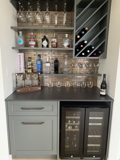 a bar with wine glasses and bottles on it