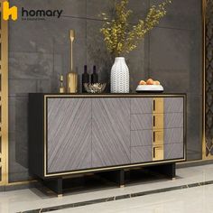 a sideboard with some bottles and vases on top of it in a room