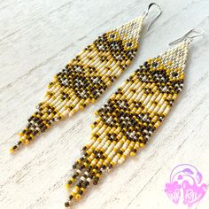 This pair features a beautiful banana yellow color, along with black lined topaz beads that have a rainbow finish!🌈  Details: 🍌Beads are professional quality Japanese and Czech glass seed beads. 🍌Ear hooks are sterling silver plated brass, lead and nickel free- they are safe for sensitive ears! 🍌Thread is strong, Japanese nylon made for beading. 🍌Length from top of the hook to the longest fringe is 5.5 inches. 🍌Each earring is approx .25 oz or 7g, making them lightweight and easy to wear. 🍌Feel free to email or message me with any questions :) You can find more of my work on Facebook, Instagram, and TikTok: https://facebook.com/inkray.art https://www.instagram.com/inkray.beadwork/ tiktok.com/@inkray.beadwork Yellow Teardrop Beaded Earrings With Dangling Beads, Yellow Beaded Teardrop Jewelry, Yellow Teardrop Beaded Jewelry, Yellow Beaded Teardrop Earrings, Yellow Teardrop Beaded Earrings With Colorful Beads, Yellow Teardrop Earrings With Dangling Beads, Adjustable Yellow Earrings With Gold Beads, Yellow Dangle Earrings With Gold Beads, Yellow Earrings With Gold Beads