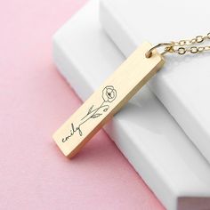 Show off your unique personality and bloom with confidence with our personalised birth flower bar necklace, the perfect birthday gift for her. She’ll wear their unique piece of jewellery wherever she goes, made even more personal and special by the birth flower design. This luxury necklace will do with any outfit, whether you're chilling at home or going out with friends - its radiance will shine through! Personalise with your loved one’s name, to make it a truly special and sentimental gift for a friend, your mum or yourself (why not, you deserve it!). Our expert team of artisans will do the rest, meticulously engraving your chosen birth month flower and personalisation onto the necklace’s pendant, for a magical gift that will forever hold a place in her heart. Your head turning necklace Berry Names, Emotional Gifts, Bar Necklace Personalized, Flower Bar, Magical Gift, Luxury Necklace, Birth Month Flowers, Perfect Birthday Gift, Black Gift Boxes