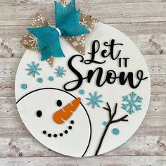 a snowman with a bow on it's head and the words let it snow