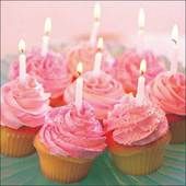 cupcakes with pink frosting and lit candles