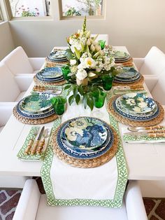 the table is set with plates and place settings