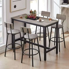 a kitchen table with four stools in front of it