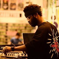 a man with headband and glasses working on a keyboard