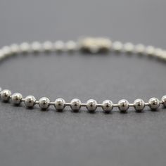 A simple yet beautiful everyday chain or bracelet. This is a bead or ball chain as some call it features 3mm beads. This is solid 925 sterling silver, not plated. You can select the shiny silver or opt to have it antiqued with the oxidized brushed patina. I measure the length in inches from end to end including the clasp. Made to Order Lengths~ Need a special length just ask! 925 Sterling Silver Bright and Shiny or Oxidized Antiqued Patina Fastens with a simple connector link The chain will arri Dainty Beaded Bracelets With Ball Chain, Minimalist Ball Chain Bracelets As Gift, Minimalist Satellite Chain Bracelet With Round Beads, Everyday Ball Chain Bracelet, Dainty Ball Chain Bracelet For Everyday, Everyday Beaded Ball Chain Bracelet, Dainty Ball Chain Bracelet For Gift, Dainty Everyday Ball Chain Bracelet, Minimalist Adjustable Chain Bracelet With Round Beads