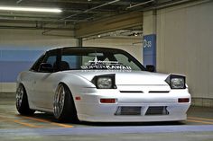 a white car parked in a parking garage