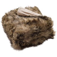 a brown fur hat on top of a white surface with a cloth in the middle