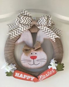 a wooden bunny wreath hanging on the wall