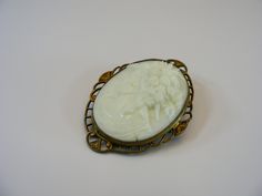 Cameo brooch, oval jewelry, cameo jewelry, filigree jewellery, boho jewellery, body jewellery, antique brooch, opaline brooch, jewelry, uranium jewelry, collectible jewelry, old, cameo --------------------------- Czech vintage opaline uranium cameo brooch. With a locking pin. Size: 1.28" W x 1.64" H  (3.3cm x 4.2cm) In vintage conditions. Please see photos for more details.  Let me know if you'll need more detailed photos. For adult use only - embellishments may have small or pointy parts. Actua Antique Carved Brooches For Weddings, Antique Cameo Brooches For Wedding, Ornate Carved Oval Brooches, Ornate Oval Carved Brooches, Antique Oval Carved Brooches, White Cameo Brooch For Wedding, White Cameo Brooch For Formal Occasions, White Cameo Brooches For Wedding, White Cameo Brooches For Formal Occasion