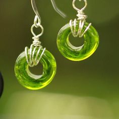 These large-holed ring beads are a simple and elegant choice! The glass bead captures light in a beautiful and incredibly unique way. This particular color is inspired by the natural green olivine mineral that is responsible for Hawaii's famous green-sand beach.  Each glass bead is melted and crafted by hand here in Kona, Hawaii. I began making glass beads and earrings at the age of 11 and my love for hand arts has only grown since! These earrings capture the island, ocean, and Aloha spirit. Ple Green Recycled Glass Bead Jewelry, Green Recycled Glass Round Bead Jewelry, Recycled Glass Jewelry With Spacer Beads As Gift, Recycled Glass Spacer Beads Jewelry As Gift, Recycled Glass Spacer Beads Jewelry For Jewelry Making, Recycled Glass Spacer Beads For Jewelry Making, Spacer Beads Jewelry With Recycled Glass For Jewelry Making, Nature-inspired Hypoallergenic Green Jewelry, Nature-inspired Green Hypoallergenic Jewelry