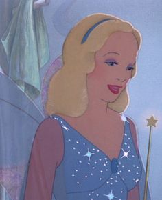 a woman with blonde hair and blue dress holding a wand