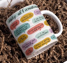 a coffee mug with words written on it in a pile of wood shavings