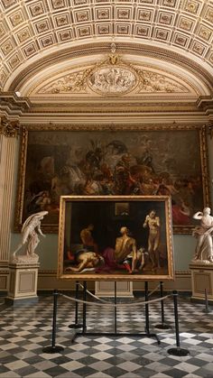 an ornate room with statues and paintings on the walls