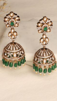 Discover the timeless elegance of these meticulously crafted jhumka earrings, designed to add a touch of regal charisma to your look. Elegant Green Jhumkas For Reception, Meenakari Earrings For Festive Reception, Intricate Design Earrings For Festive Reception, Fusion Style Stone Work Earrings For Festive Season, Hand Set Jhumkas For Diwali Reception, American Diamond Jhumkas For Receptions And Festivals, Green Earrings For Reception And Festive Occasions, Fusion Style Danglers For Diwali Reception, Festive Stone Work Danglers For Reception