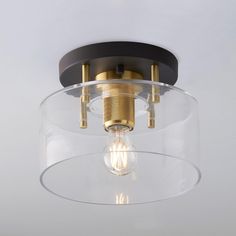 a light that is inside of a glass bowl on a ceiling fixture in a room