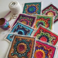 crocheted coasters are laid out on a table