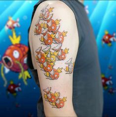 a man with a tattoo on his arm that has many small fish in the water