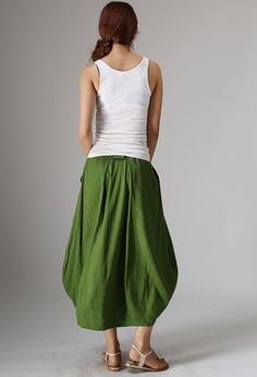 "High-rise midi skirt from Xiaolizi. The green skirt made from linen fabrication in a bubble silhouette. The long linen skirt topped with a button-zipper fly + banded waist. The summer skirt features side-entry pockets at the hips. The womens skirts finished with pleating details. DETAIL * Linen cotton blend * 50% Linen, 50% cotton * Twin pockets * Belt loops * Zipper and button closure * Hide zipper in the front side * Bubble skirt * Pleated on the waist * Mid Calf length * Wash by hand or mach Long Linen Skirt, Linen Midi Skirt, Skirt Linen, Midi Skirt With Pockets, Tailored Clothes, Handmade Skirts, Green Bubble, Womens Skirts, Skirt Summer